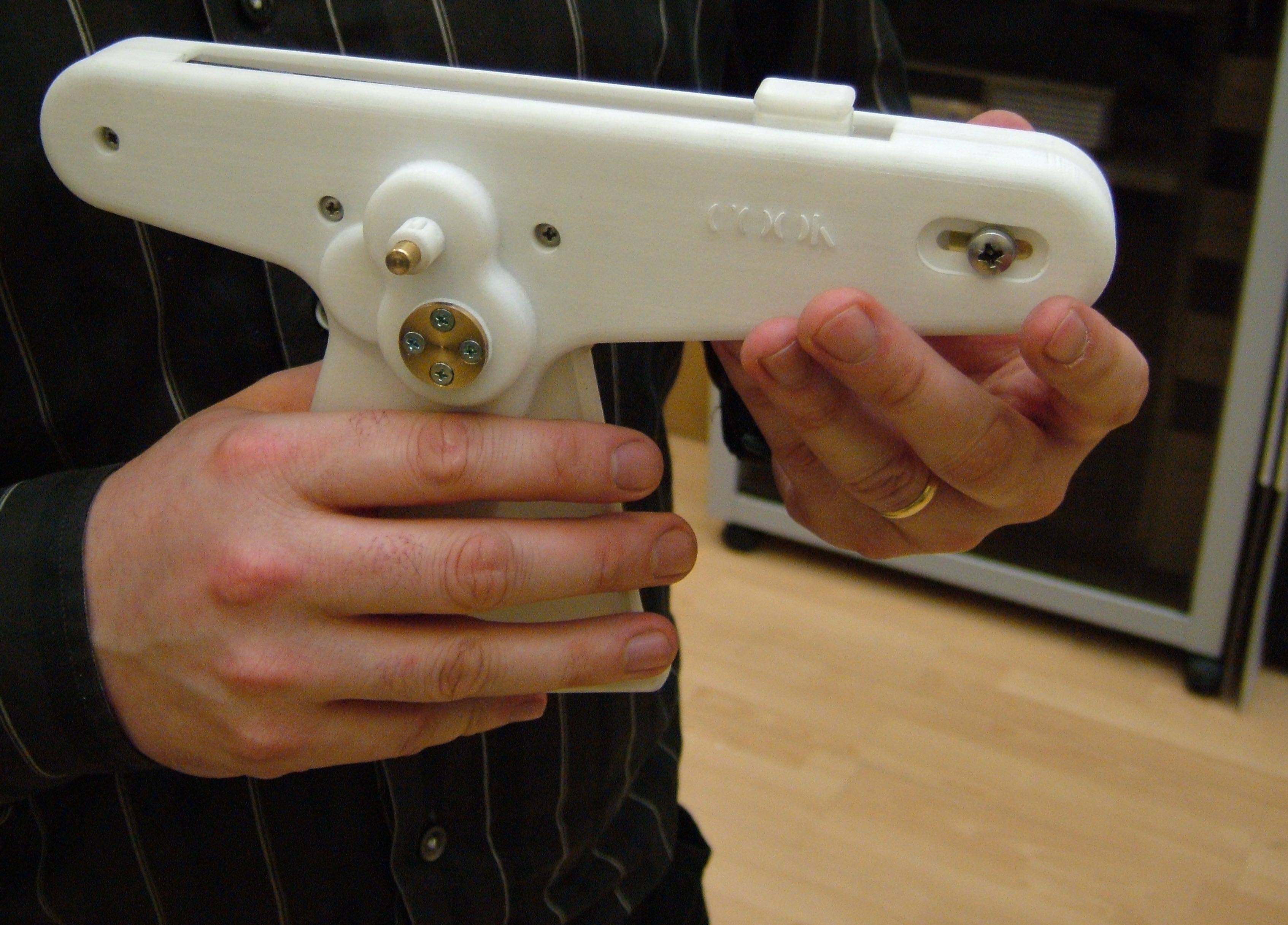 Hands holding the early cook evolution prototype