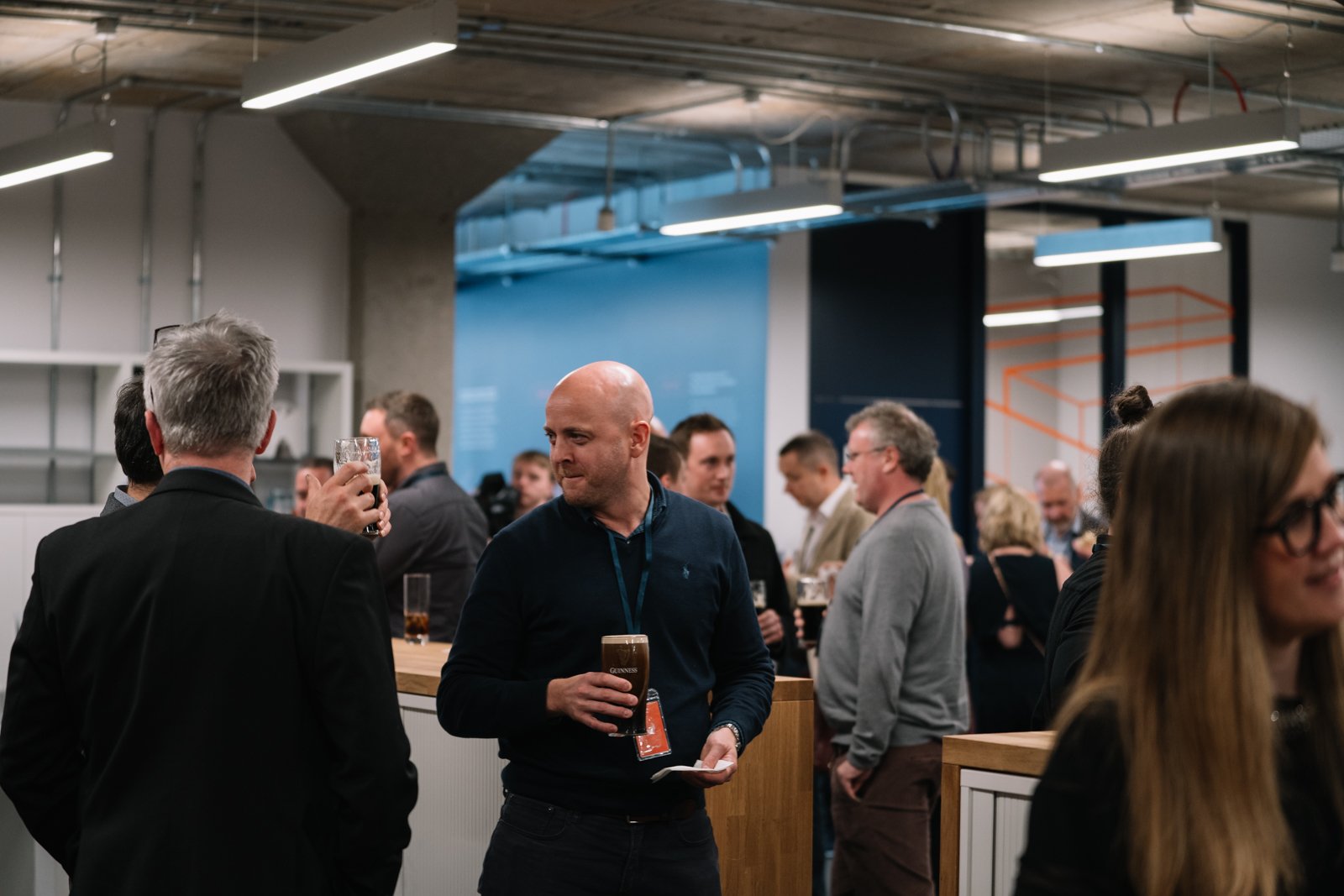 A product designer holding a Guinness at a company event